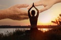 Double exposure of woman meditating and hands reaching each other outdoors at sunset. Yoga helping in daily life: harmony