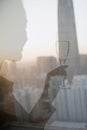 Double exposure of woman toasting with champagne flute over cityscape, Beijing, China Royalty Free Stock Photo