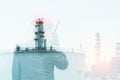 Double exposure workers hand holding walkie talkie, communication in oil refinery plant