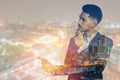 Double exposure young asian businessman with tablet communicating isolated on city background Royalty Free Stock Photo
