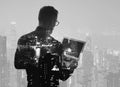 Double exposure young bearded businessman wearing black shirt and holding modern notebook hands. Panoramic view contemporary night