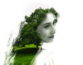 Double exposure of young beautiful girl among the leaves and trees. Portrait of attractive lady combined with photograph of tree. Royalty Free Stock Photo