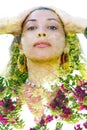 Double exposure portrait of a beautiful exotic woman with hands on head, combined with photograph bright green leaves with pink
