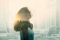 Double exposure with young woman in the modern cityscape and forest Royalty Free Stock Photo