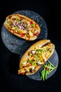 Fast food hotdog with beef sausage and fresh grilled vegetables with wheat bun on wooden background Royalty Free Stock Photo