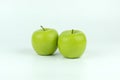 Double fresh green apples isolated on white background with clipping path.