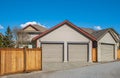 Double garage with short driveway in a sunny day. Garage Door in a perfect neighbourhood