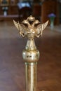 Double-headed eagle with two swords, cross and crown in the church Royalty Free Stock Photo