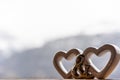 Double Heart shape as symbol of love. For Valentine`s or wedding day concept. Blurry snow mountain in background. Side view Royalty Free Stock Photo