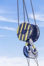 Double hook of a port crane close-up on a blue sky background