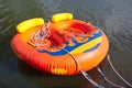 Double inflatable raft of orange color on the water surface. Royalty Free Stock Photo