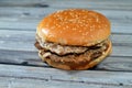 Double juicy thick beef patty with cheese covered with sauce, mushroom in a large sesame seed bun, a beef burger hamburger Royalty Free Stock Photo