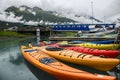 Double kayaks parked on the pier on scenic mountain ocean bay in Valdez, Alaska.