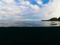 Double landscape with sea and sky. Above and below waterline in tropical seashore.