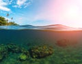 Double landscape with sea and sky. Split photo with tropical island and underwater coral reef. Royalty Free Stock Photo