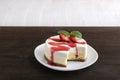 Double layer cheesecake with fresh strawberries and berry syrup