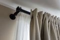 Double layer curtains on black rod in living room