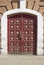 massive wooden doors of a brick house