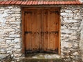 Double-leaf wooden door in a stone wall Royalty Free Stock Photo