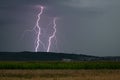 Double lightning strike just behind a hill Royalty Free Stock Photo