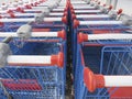 Double lined shopping carts. Rows of blue shopping carts collected in supermarket. Royalty Free Stock Photo