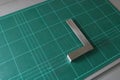 Metal angle square on green cutting mat background Royalty Free Stock Photo