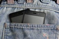 Double Mobile phone, cellphone in back pocket blue jeans Royalty Free Stock Photo