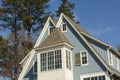 Double-peaked roof of blue family home