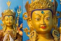 Double photograph showing gold covered statue of tibetan buddhist master Guru Rimpoche. Royalty Free Stock Photo