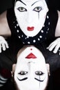 Double portrait mimes with green eyes