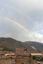 Double rainbow in the afternoon, with view of some adobe and brick houses, mountains and sky, taken in the afternoon in Caraz