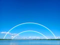 Double rainbow with blue sky and white cloud on lake surface Royalty Free Stock Photo