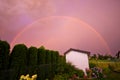 Double rainbow over a garden in pink color