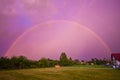 Double rainbow over a garden in pink color