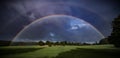 Double rainbow over green fields