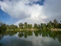 double rainbow over a lake with trees in the background Royalty Free Stock Photo