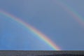 A double rainbow over the roof of a building Royalty Free Stock Photo