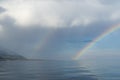 Double rainbow over the sea surface. Haze over the water. Wonderful seascape Royalty Free Stock Photo