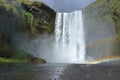 Double Rainbow and Dark Clouds at Powerful Skogafoss Waterfall, Katla Geopark, South Coast of Iceland Royalty Free Stock Photo