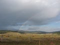 A double rainbow under haystacks