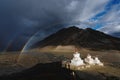 Double rainbows and overcast rainy sky and pagodas in Zanskar valley, India