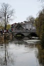 A double rch stone bridge crosses a river in Lijiang