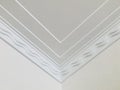 Double row wave pattern crown molding in expensive home ceiling at the corner ornamental. close up.