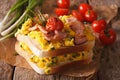 double sandwich with scrambled eggs, bacon and tomatoes close-up. Horizontal Royalty Free Stock Photo