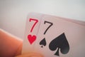 Double seven, Playing cards in hand on the table, poker nands