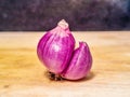 Double Shallot Growing Together on a Wooden Surface. Royalty Free Stock Photo