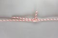 Double sheet bend ship knot on grey background