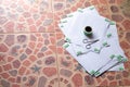 Double-sided adhesive, high angle Stick behind the white paper, and small scissors on top of all the paper placed on the patterned