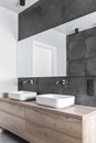 Double sinks in white, concrete and wooden bathroom interior Royalty Free Stock Photo