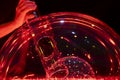 double soap bubble made with a tube and illuminated in red creating an original effect